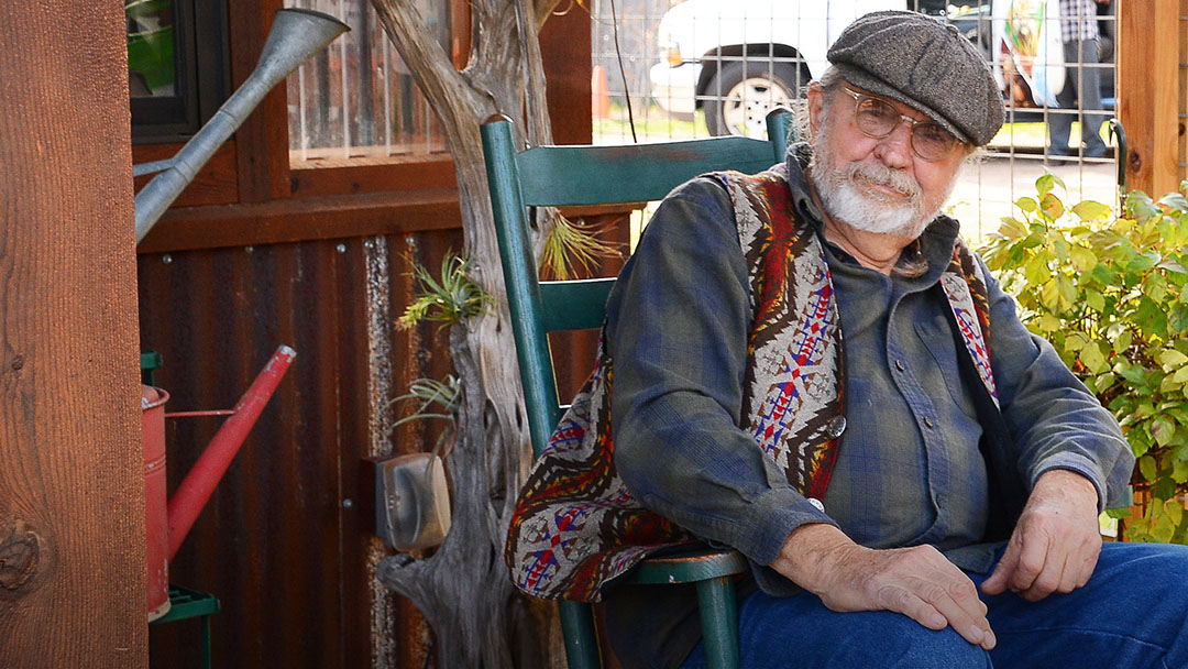 man with calm expression in rocking chair on porch